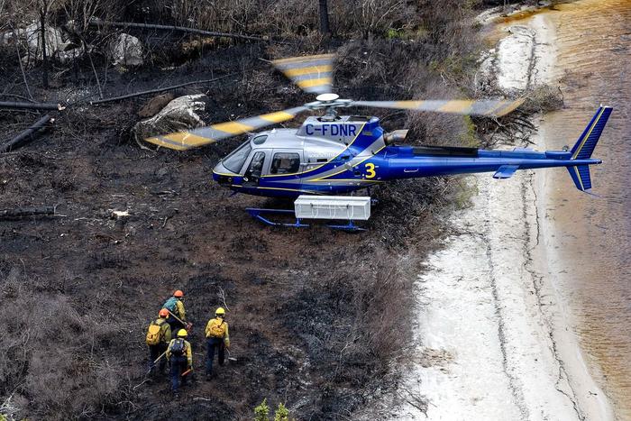 6月22日，加拿大新斯科舍省，一架自然资源和可再生能源部的直升机在加拿大谢尔本地区运送一名野火队员。